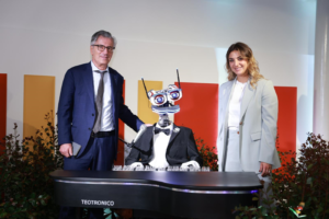 Giampiero Maioli, AD di Crédit Agricole Italia, e Annarita D’Urso, Managing Director di Le Village by CA Sicilia, posano di fianco a un robot che suona un pianoforte, sviluppato da una delle startup siciliane dell'ecosistema di accelerazione dell'hub